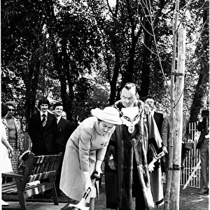 Queen Elizabeth II plants a silver birth tree in the aromatic gardens, St Helens
