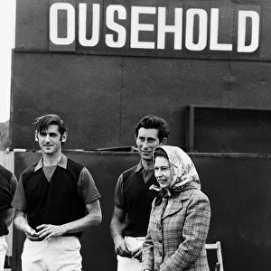 Queen Elizabeth II and Prince Charles June 1979 laugh at the score board at a polo