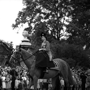 Queen Elizabeth II rides her horse sidesaddle June 1953 towards horseguards parade