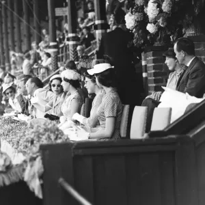 Queen Elizabeth II seen here chatting with Princess Margaret in the royal box