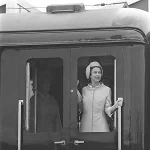 Queen Elizabeth looks out of the Royal Train after arriving in Wales the Investature of