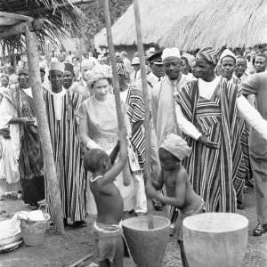 Queen Elizabeth watches two children grinding corn during a visit to Hangha in Kenema Queen Elizabeth watches two children grinding corn during a visit to Hangha in Kenema