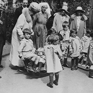 Queen Mary visits Orphanage. Queen Mary and local mayor visit orphans at playtime