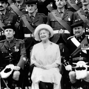Queen Mother sitting with soldiers of the 1st Battalion 51st Highland Volunteers