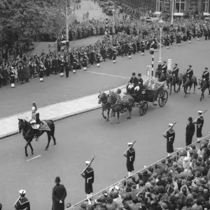The Queen of Tonga waves to the crowds in Northumberland Avenue