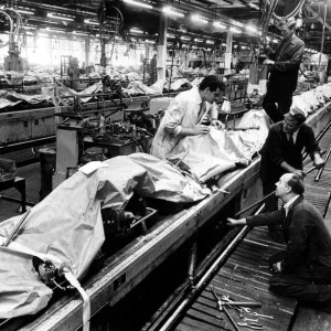 In a quiet and deserted East Works at Longbridge, car engines are covered with brown