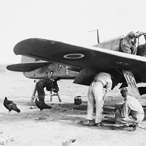 R. A. F. AT Advanced airfield in Italy. R. A. F. fitters busily at work on an aircraft