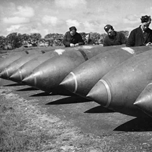 R. A. F. armourers working with 12, 000 lb bombs. Lancaster Bombers have been