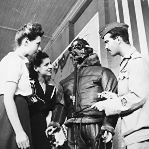 R. A. F. pilot speaking to french women regarding clothing worn by flying men of the R. A. F