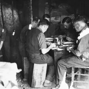 Some R. A. F. regiment officers at breakfast. On the right is Wing Commander E. N. Downes Some R. A. F. regiment officers at breakfast. On the right is Wing Commander E. N. Downes