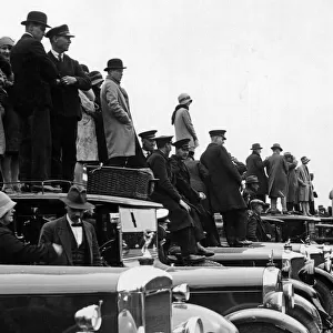 Racegoers standing on and beside their cars at Derby Day, Epsom. Circa 1927