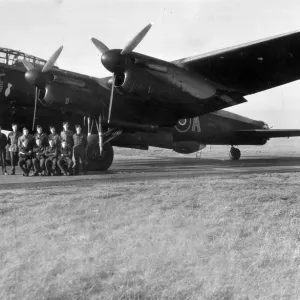 An RAF crew pose for a group photograph beside the veteran Lancaster bomber An RAF crew pose for a group photograph beside the veteran Lancaster bomber