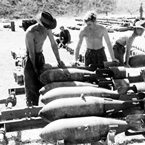 RAF ground crew in Burma loading 250lb bombs on to loading trolleys at an advanced