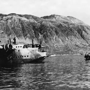 RAF personnel being rowed out to a waiting Sunderland Flying Boat