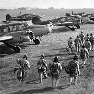 RAF pilots and crew make their way to their Avro Anson planes during World War Two
