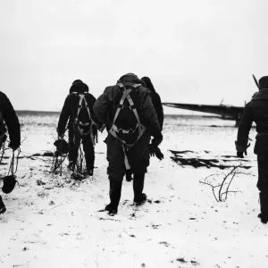 RAF pilots trudge through the snow to their aircraft on a French aerodrome for a flight RAF pilots trudge through the snow to their aircraft on a French aerodrome for a flight