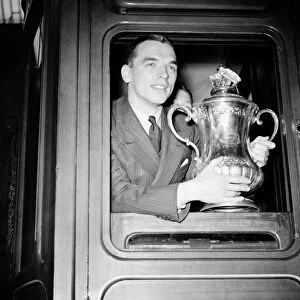 Raich Carter, captain of Sunderland football team, holding the FA Cup