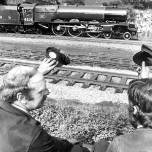 Railway enthusiasts Pete Reid from Ken and Dave Wescott from Derby salute the pass by of