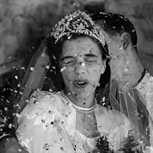 Its raining confetti. The happy bride under the barrge of confetti is 19years old