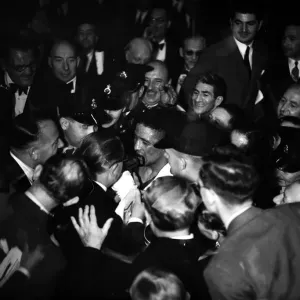 Randolph Turpin makes his way to the dressing room through the crowds after his fight