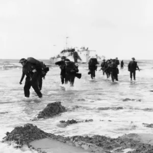 Red Cross personnel wade ashore from landing craft on Queen sector Red Cross personnel wade ashore from landing craft on Queen sector