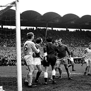 Referee Harry New steps in to calm a dispute between Nobby Stiles of Manchester United