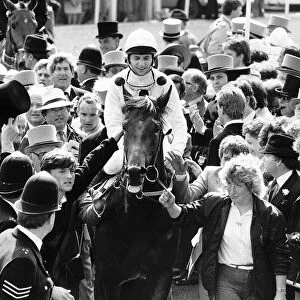 Reference Point with jockey Steve Cauthen being escorted to the winners enclosure after