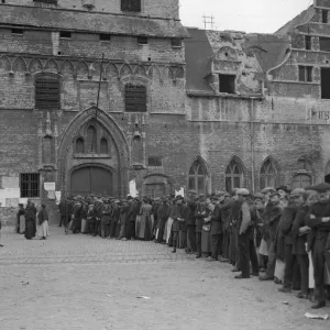 Refugees from the fighting seen here queuing outside the City Hall in Malines waiting for