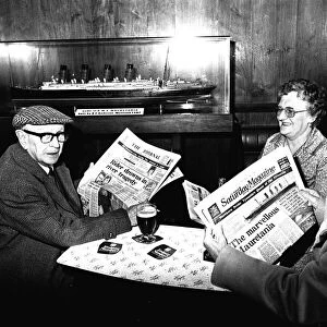 Three regulars at the Mauretania Pub in Wallsend, reading a copy of the Newcastle Journal