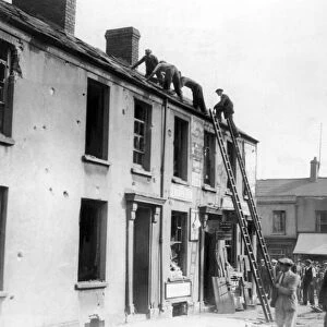 Removing roof slates after air raid in Penarth, Wales. Circa 1941