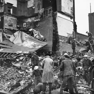 Rescue workers search debris at a bombed house in North West London. January 1941 Rescue workers search debris at a bombed house in North West London. January 1941
