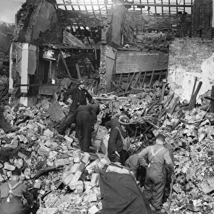Rescue workers search rubble for survivors after a parachute mine detonated on Bean