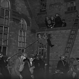 Rescuing a casualty. A series of realistic exercises were carried out at the A. R. P Rescuing a casualty. A series of realistic exercises were carried out at the A. R. P