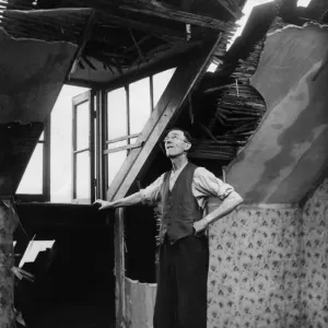 A resident of an East Yorkshire town surveys the damage to his home caused by a German