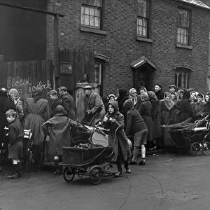 Residents of Birmingham queue with their prams at the Coal Merchants in Green Lane