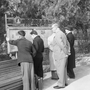 Residents reading Izvestia newspaper print, Simferopol park, April 1960
