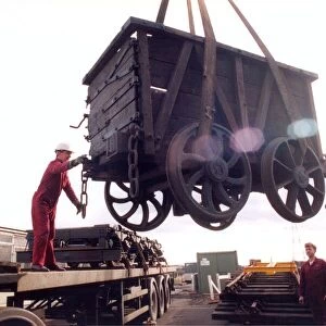 Restoration engineer Grodon Stark, on the flat bed is helping to move an anciet wagon at