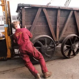 Restoration engineer Grodon Stark, on the flat bed is helping to move an anciet wagon