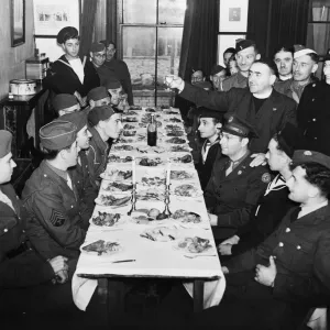 Rev. M. Goodman raises the Kiddush Cup to Jewish troops at a Kosher meal