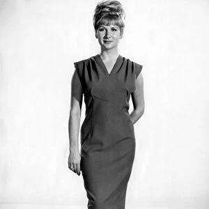 Reveille Fashions: Caron Gardner modeling sleeveless summer dress. December 1964 P007559