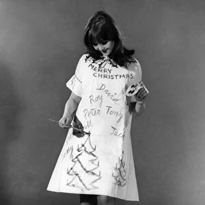 Reveille Fashions: Joanne Young decorating her own christmas dress. December 1966 P006647