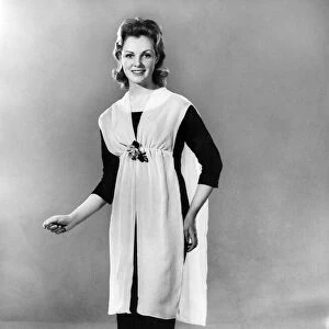 Reveille Fashions. Mannequin modelling apron. March 1960 P006993