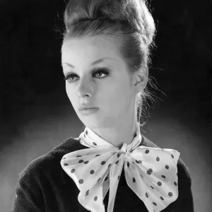 Reveille Fashions. Mannequinn modeling a scarf tied into a bow. January 1964 P007553 Reveille Fashions. Mannequinn modeling a scarf tied into a bow. January 1964 P007553