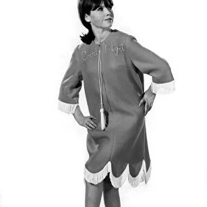 Reveille Fashions: Rosemary Bell wearing scalloped night dress. December 1964 P007582