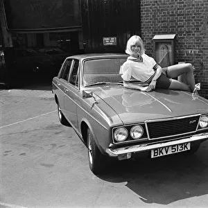 Reveille model Nancy Lee seen here posing with a Hillman Sunbeam which is top prize in