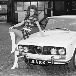 Reveille model seen here posing with a Alfa Romero car which is top prize in the Reveille