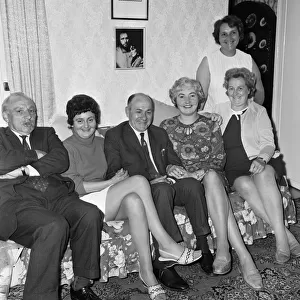 Richard Burtons family at home with a picture of him
