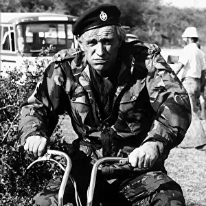 Richard Harris Irish actor on set of film Wild Geese 1977 riding motorcycle in army