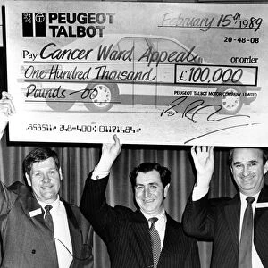 Richard Parham(right), assistant MD at Peugeot get help with the oversized cheque