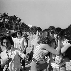 Ringo Starr is besieged by schoolgirls as he strolls on a beach in Miami, Florida